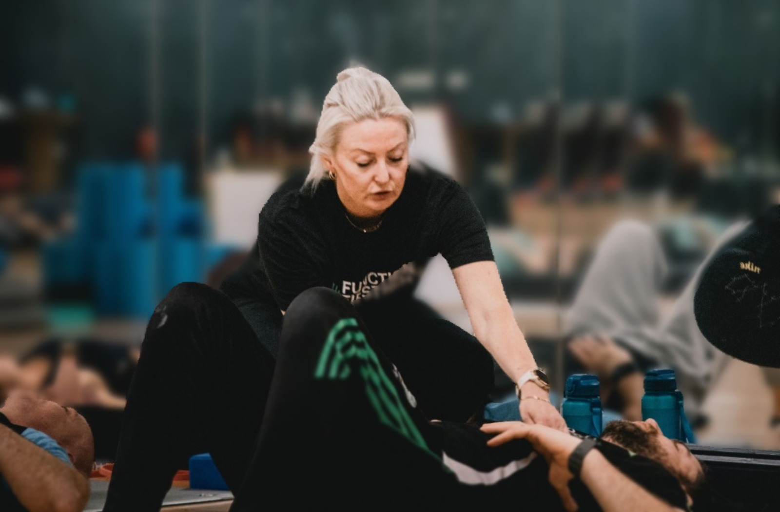 Riona coaching a client through rehab on the gym floor